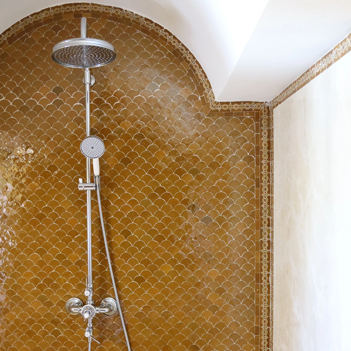 Handcrafted golden Zellige tile bathroom shower installation with traditional Moroccan-inspired design.