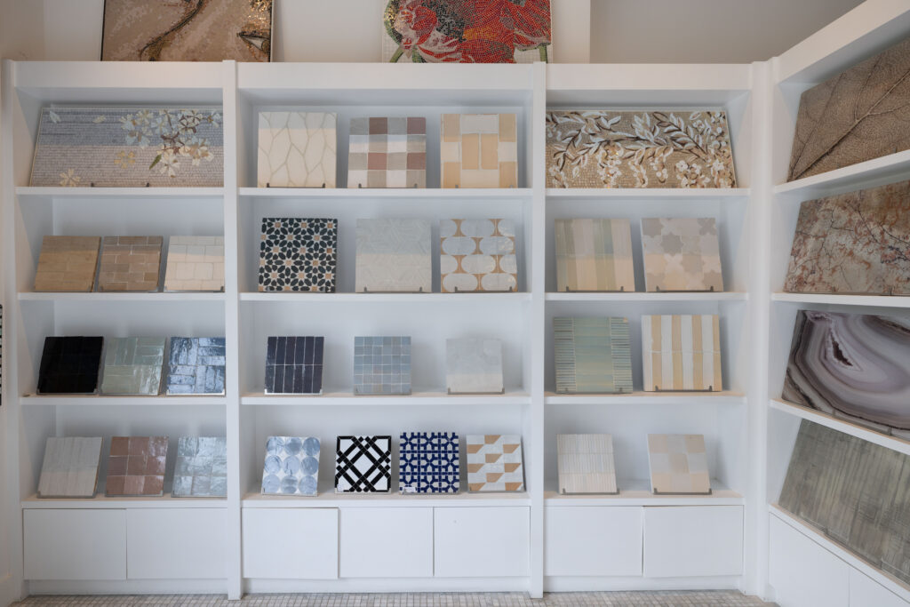 Curated tile, stone, and mosaic material displays inside the Famosa Tile showroom in Costa Mesa, California.