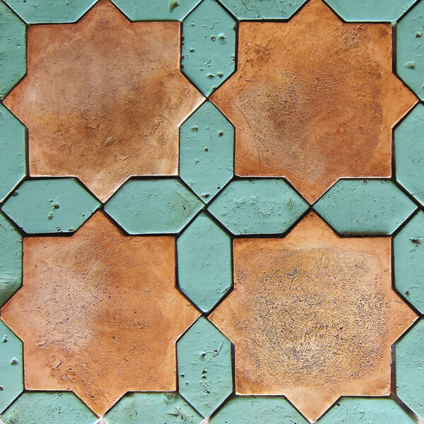 Close-up of handmade terracotta tile featuring natural color variation and artisan craftsmanship.