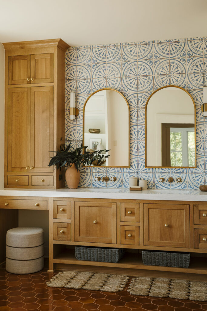 Warm kitchen featuring terracotta tile flooring, natural wood cabinetry, and Mediterranean-inspired design in a California home.