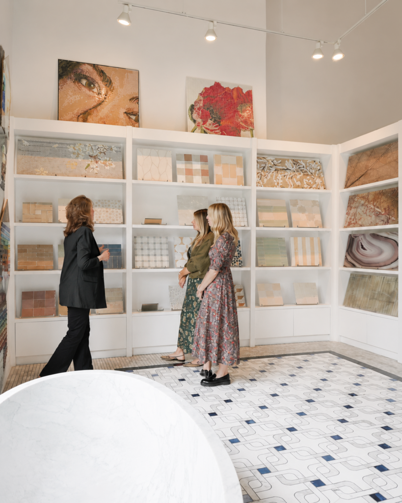 Visitors explore textured and handmade tile collections at the Famosa Tile showroom in Costa Mesa, comparing tile styles and finishes for residential design projects.