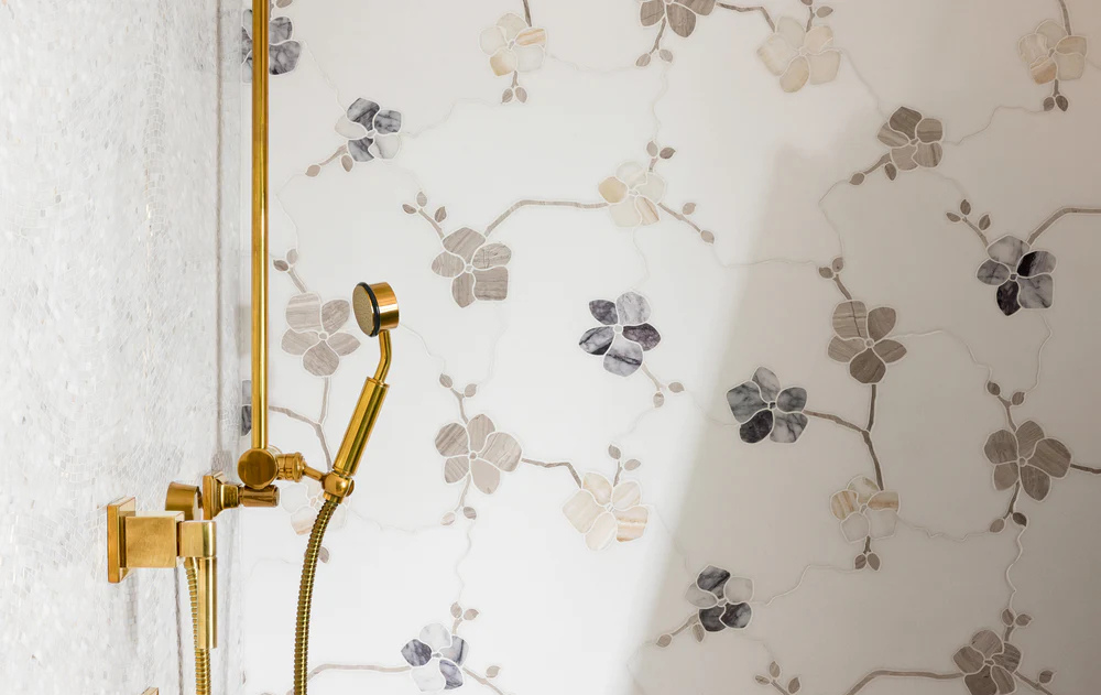 Luxury shower installation featuring decorative floral tile from the Famosa Tile showroom in Costa Mesa, showcasing artisan tile design and custom craftsmanship.
