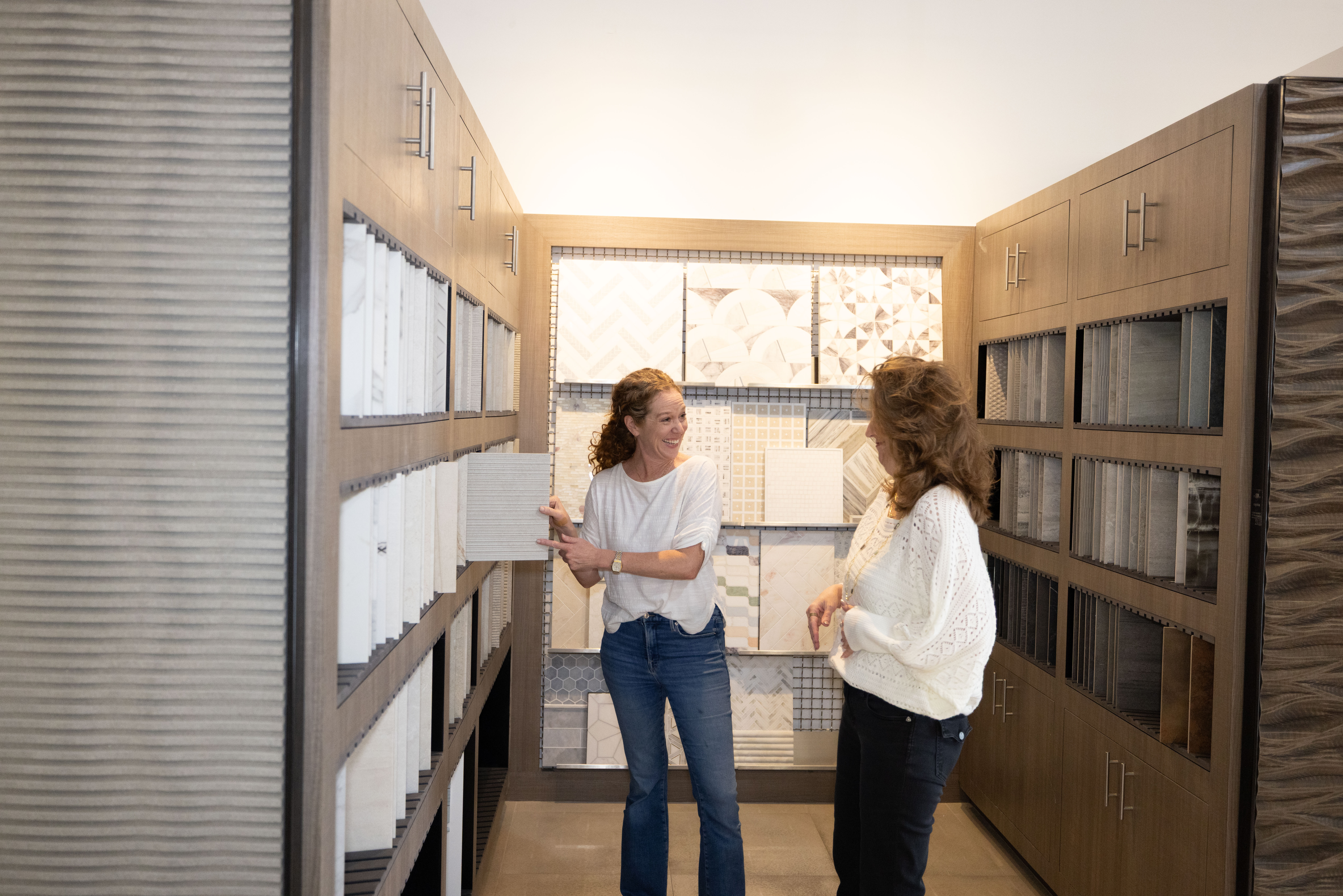 Vanessa Becking reviewing tile samples with a client during a design appointment at the Famosa Tile showroom in Costa Mesa.